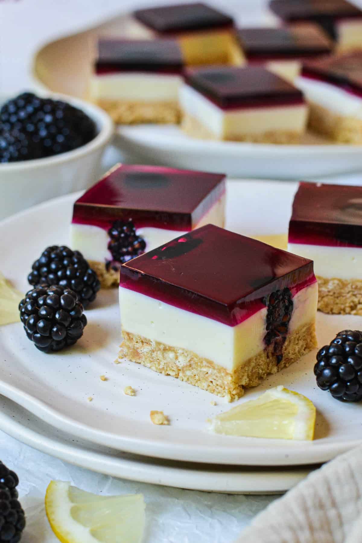 jelly slice on a plate with lemon and blackberries