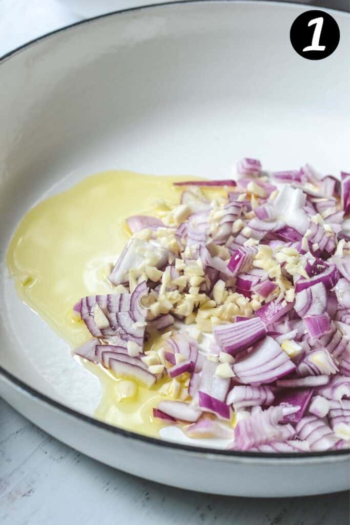onion and garlic in a white pan