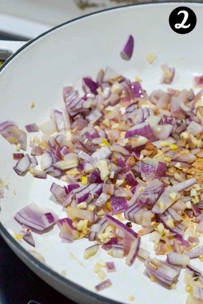 cooked onions in a white pan