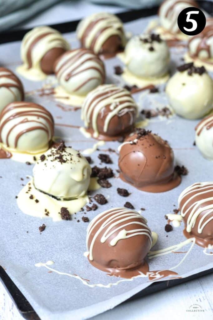 oreo balls covered in chocolate on a lined tray