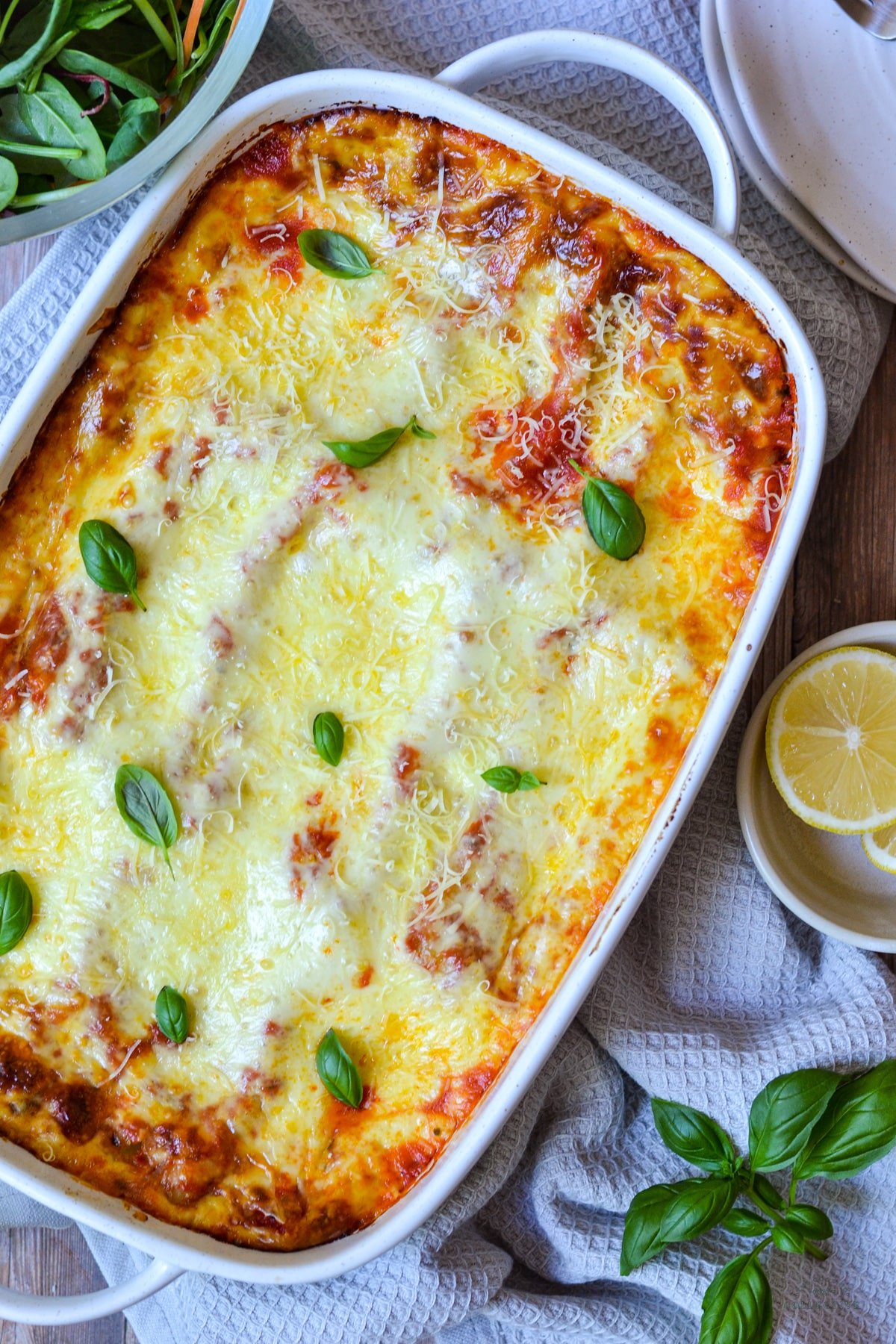 top view of baked cannelloni in a white baking dish