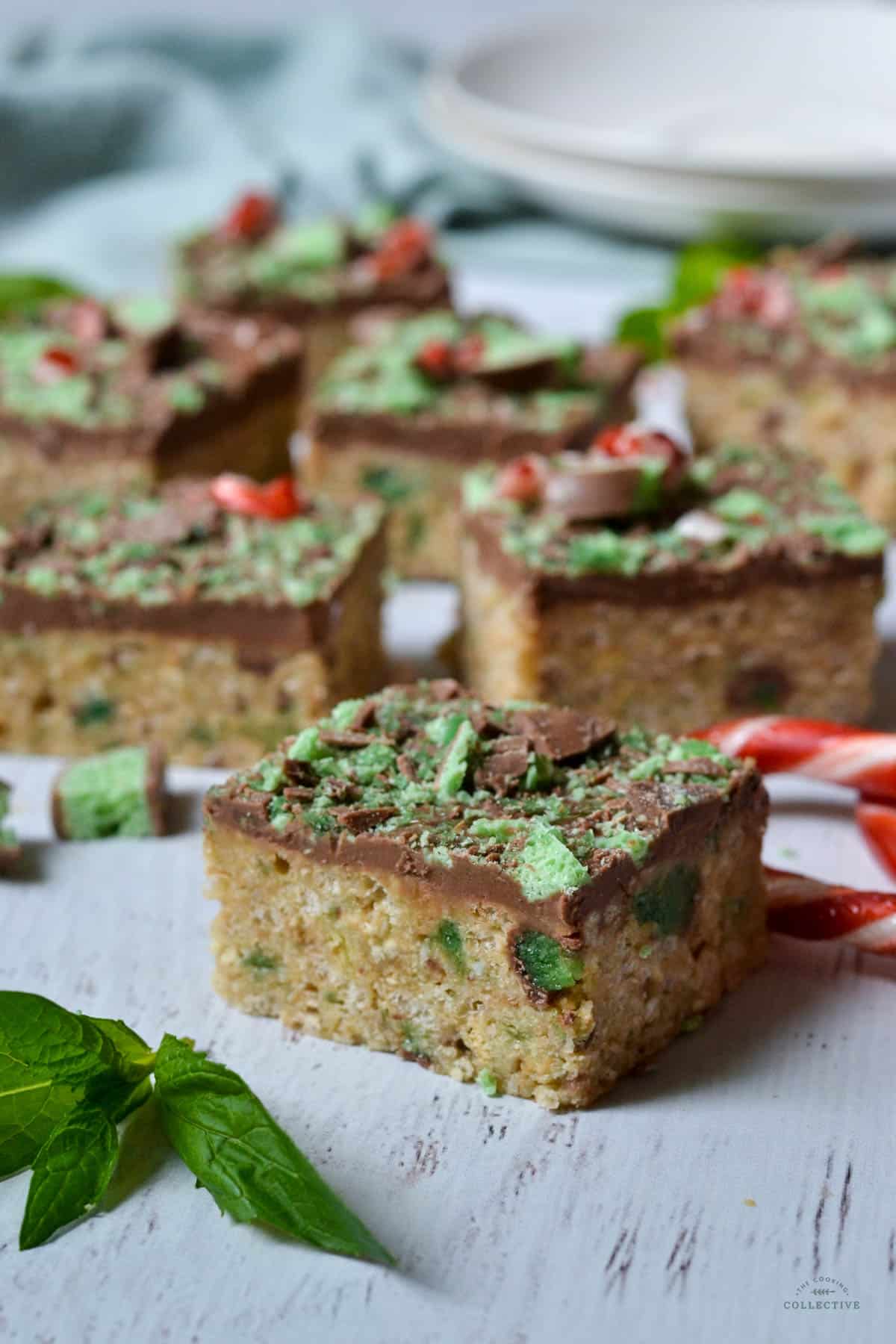 mint slice on a wooden table with mint leaves and candy canes