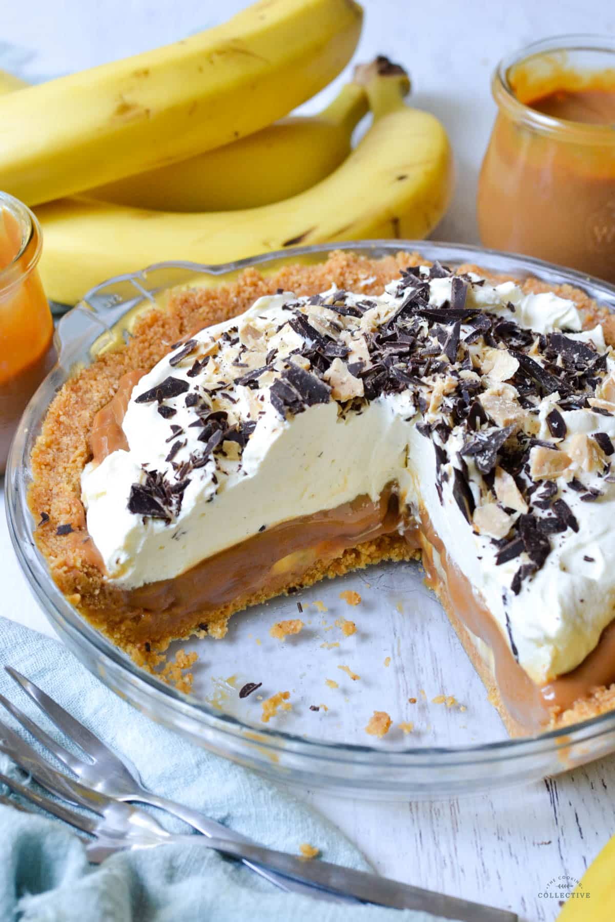 banoffee pie with a piece cut out, in a pie dish
