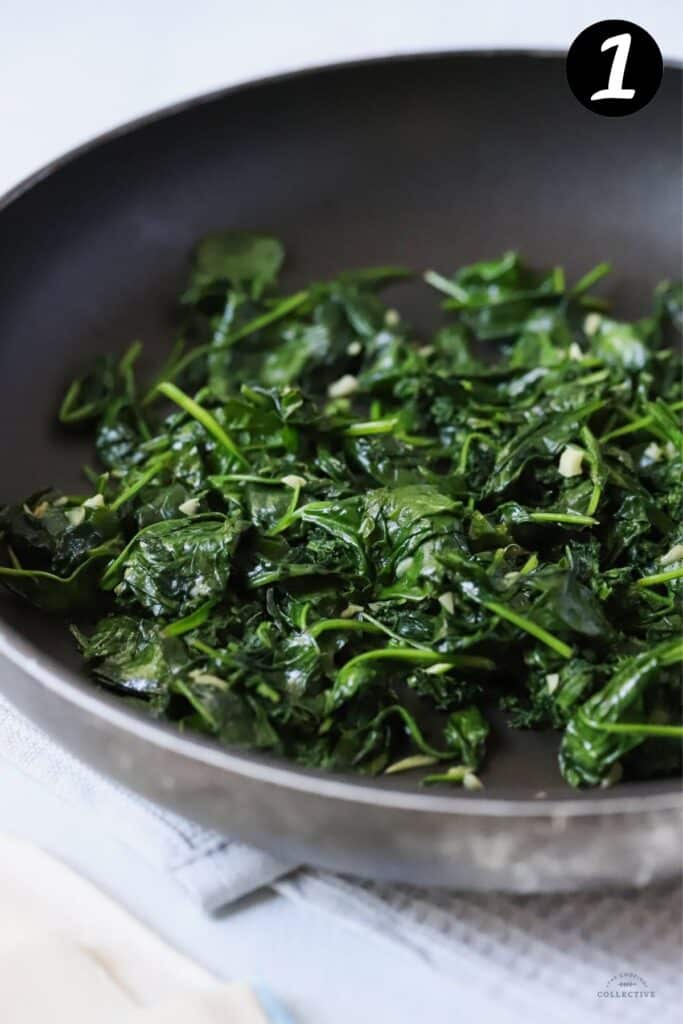 wilted spinach leaves in a frying pan
