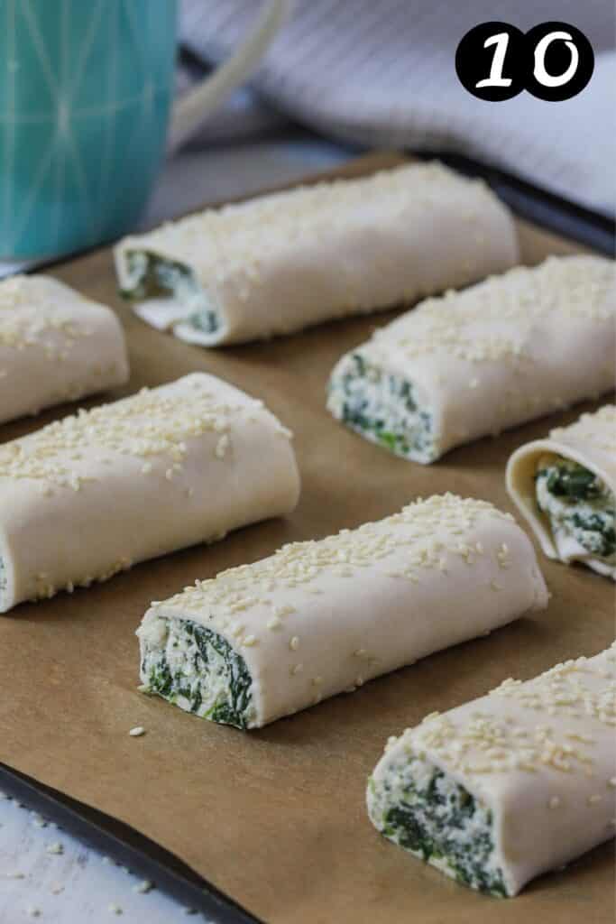 spinach and ricotta rolls on a baking tray