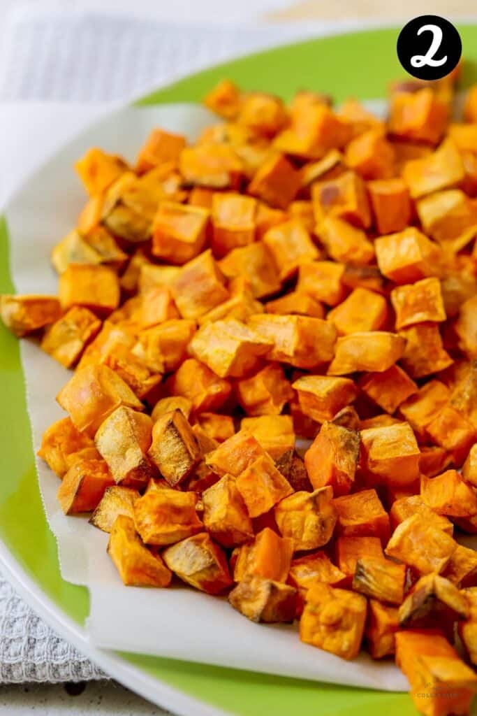 roasted sweet potato cubes on a green plate