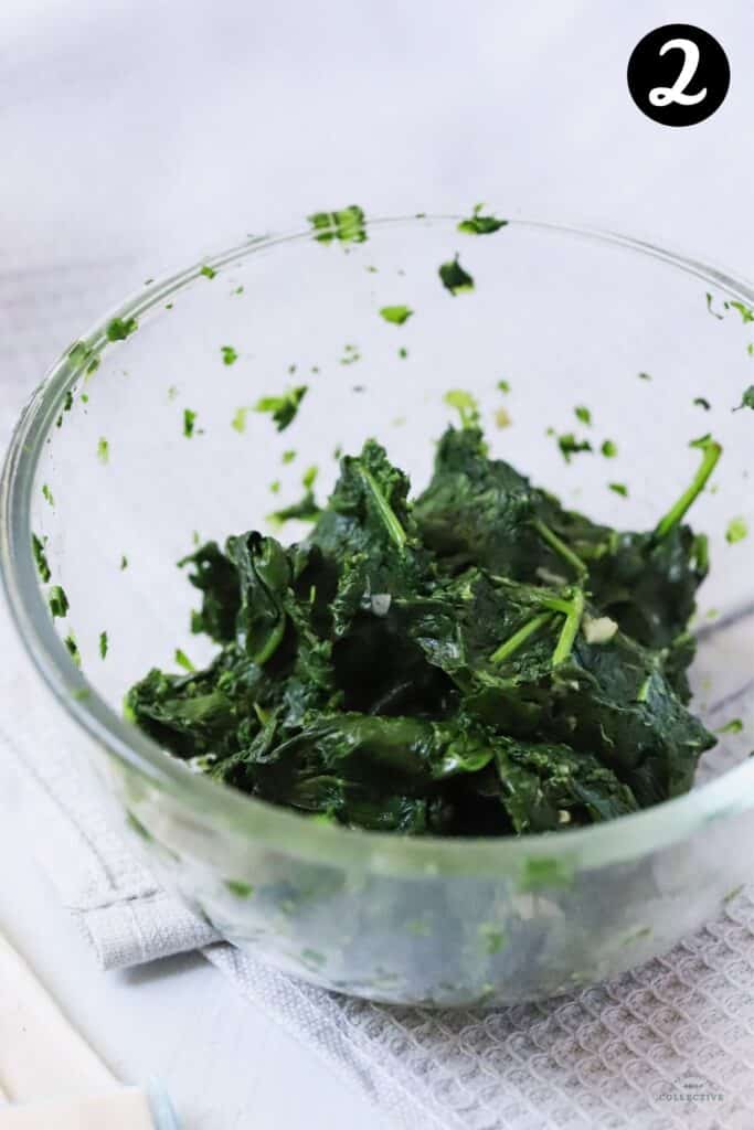 Drained spinach leaves in a glass bowl