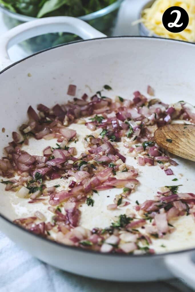 garlic and onion cooked in a white pan