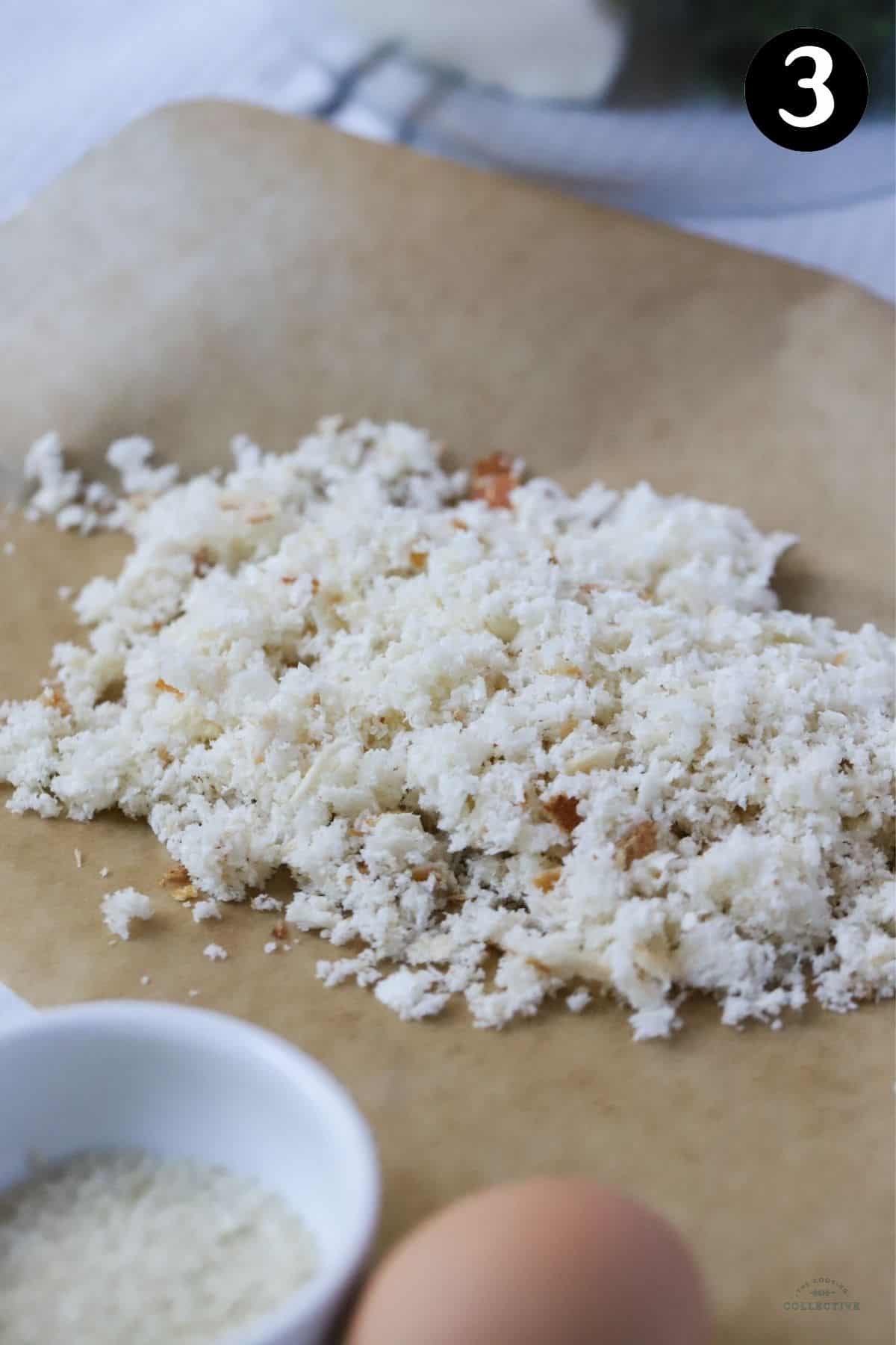 fresh breadcrumbs on a brown sheet of baking paper