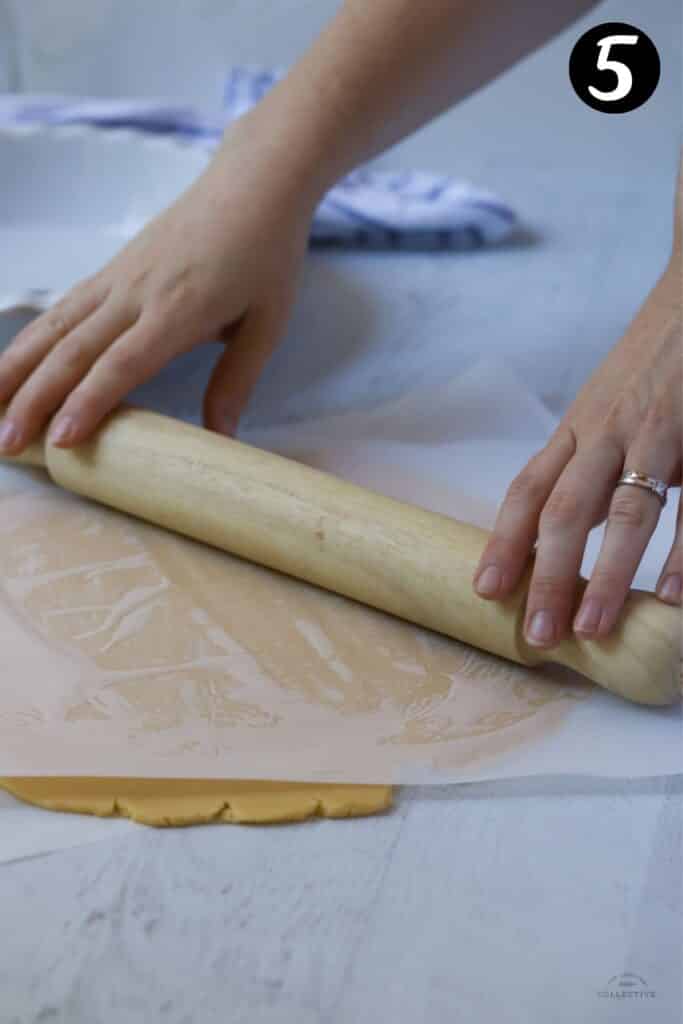 hands holding a rolling pin, rolling pie dough