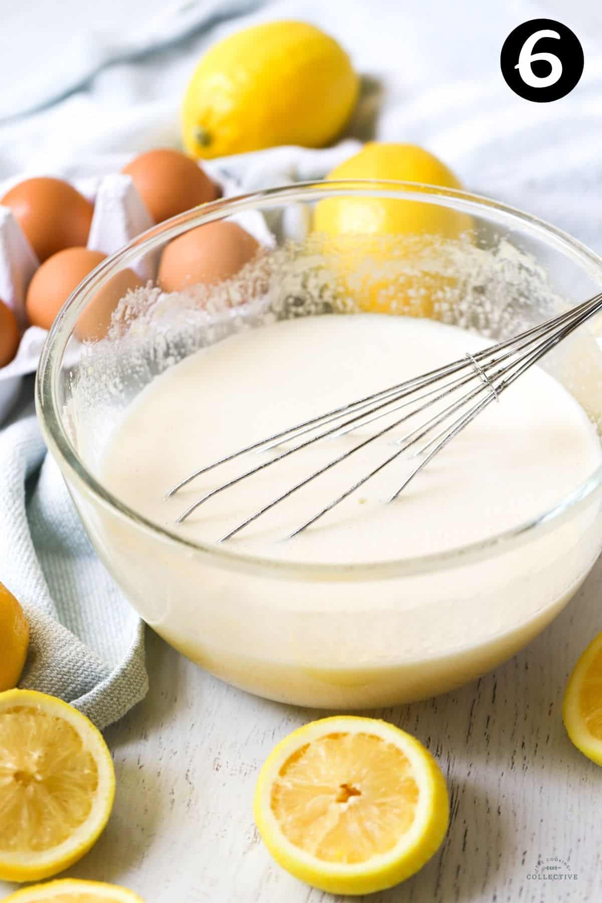 lemon mixture in a glass mixing bowl, with a whisk