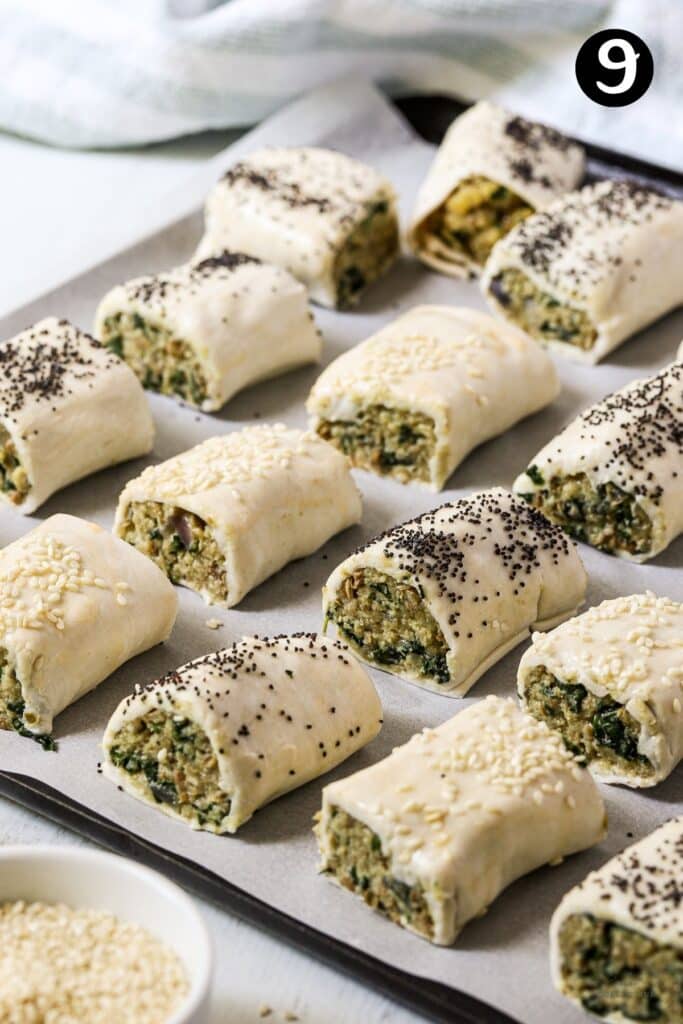 uncooked veggie rolls on a baking tray, ready to be added to the oven