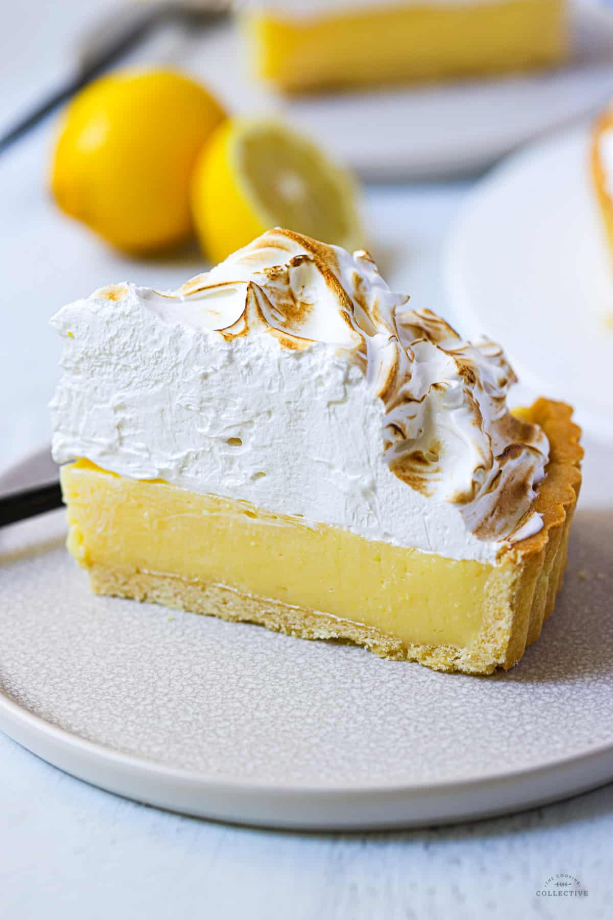 close up of a slice of lemon meringue pie on a plate