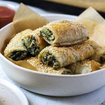 spinach and ricotta rolls in a white bowl