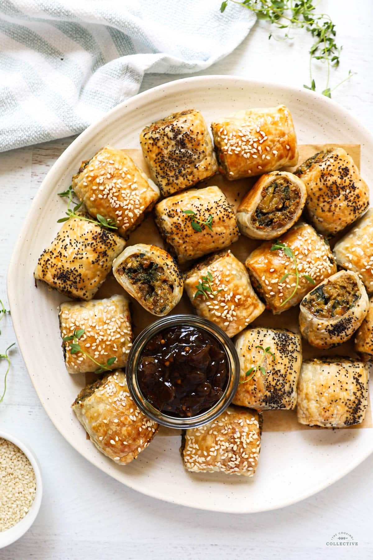 finished sausage rolls on a white plate with dipping sauce