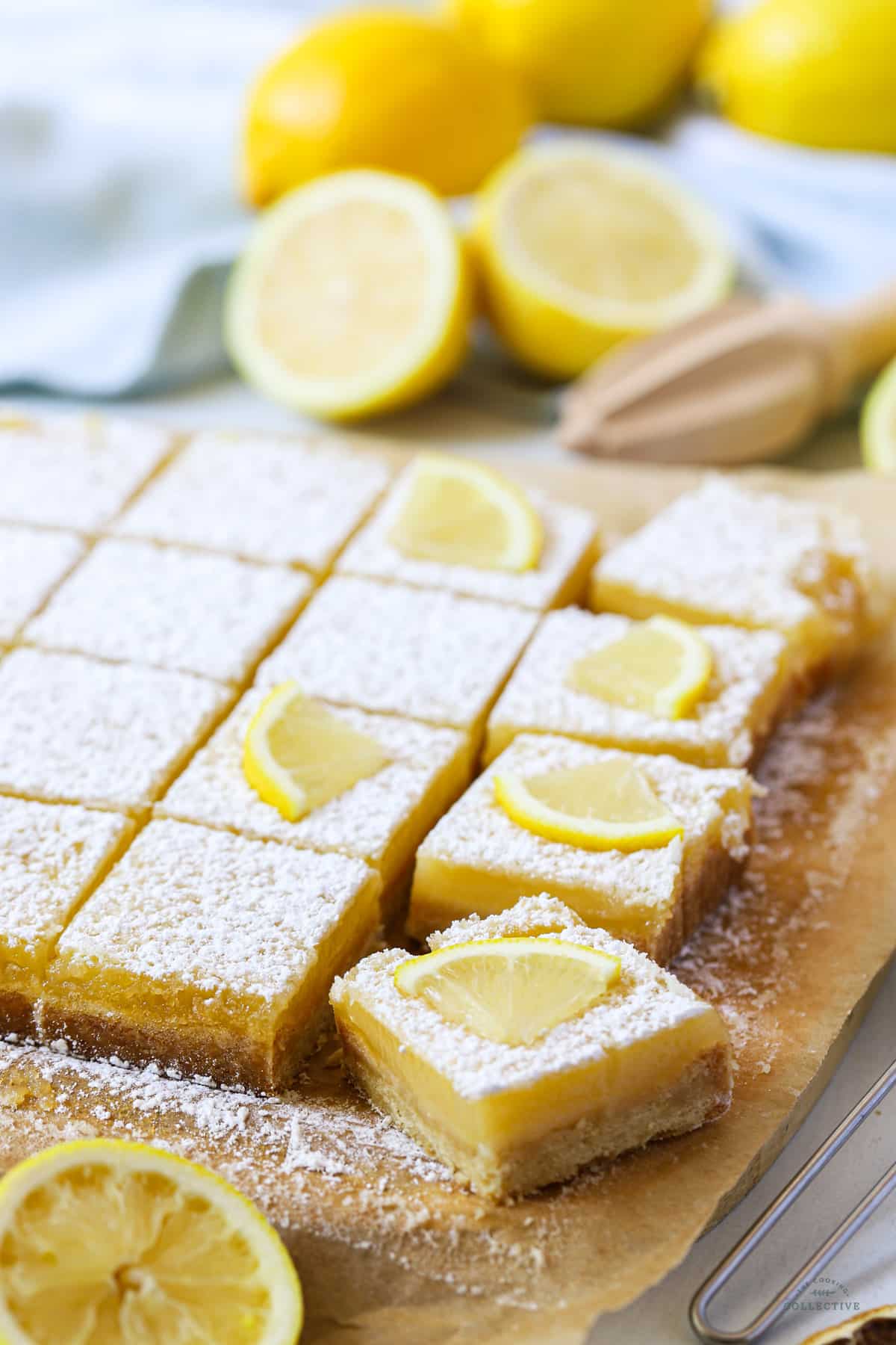 finished lemon squares on a table topped with lemon and icing sugar