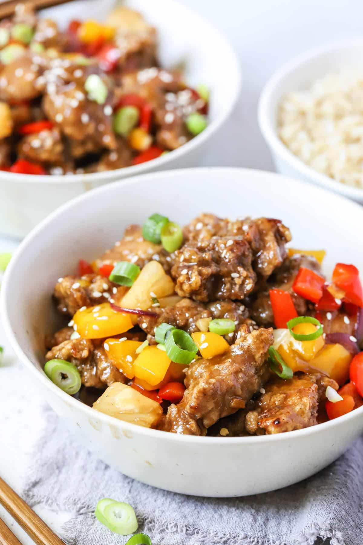 battered pork and vegetables in a bowl with sweet and sour sauce