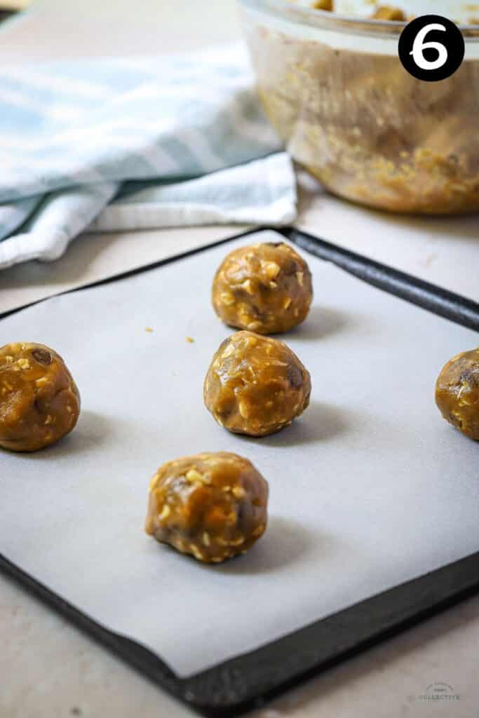 cookie dough rolled into balls on a baking tray