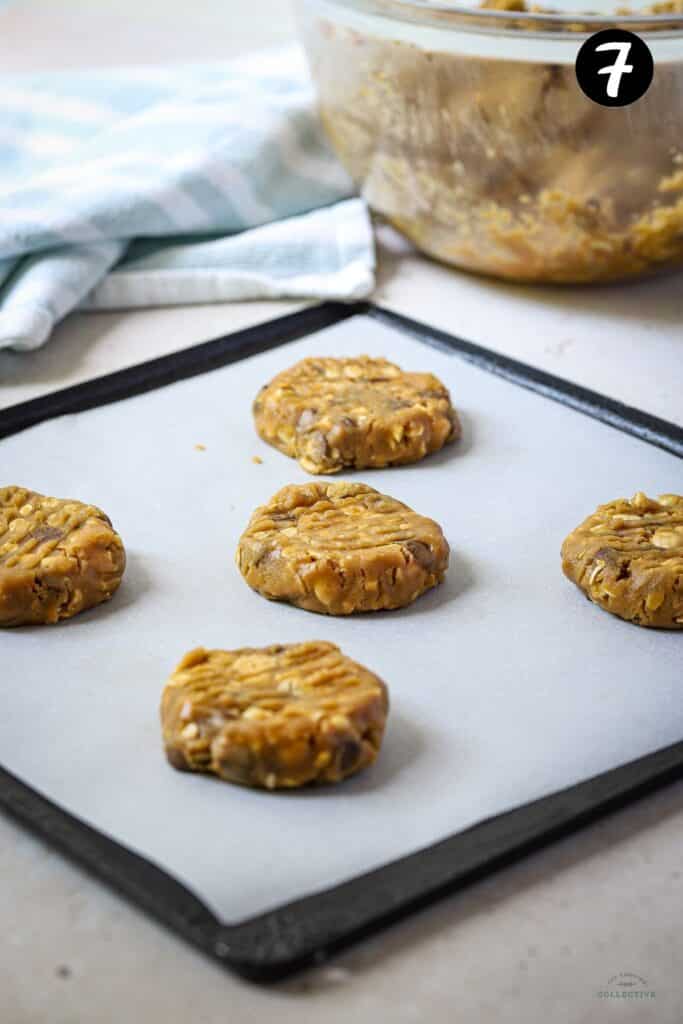 flattened cookie dough on a baking tray