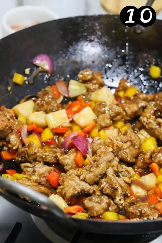 sweet and sour pork with vegetables in a wok