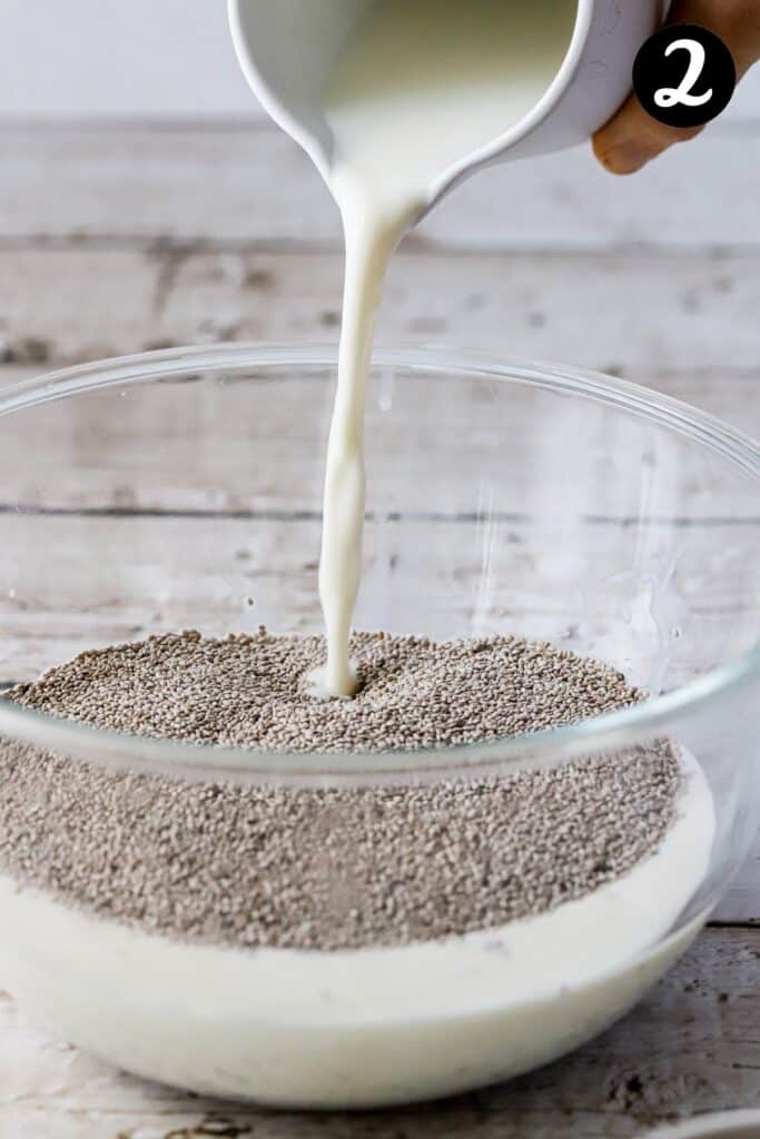milk being poured over chia seeds in a bowl