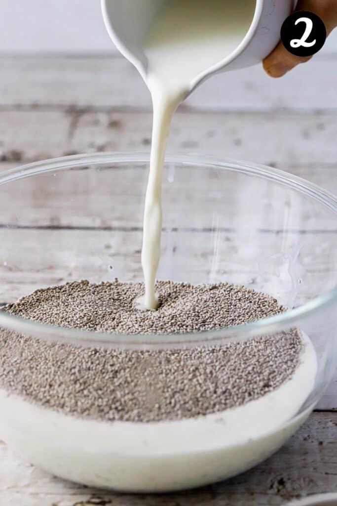 milk being poured over chia seeds in a bowl