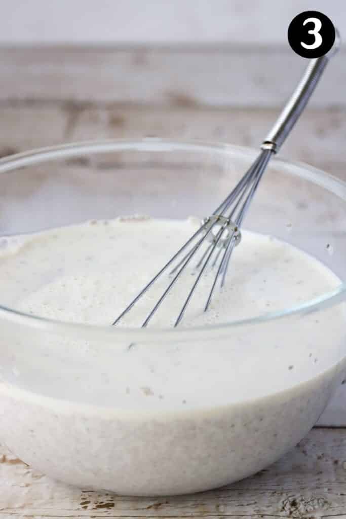 chia seed pudding in a bowl with a whisk