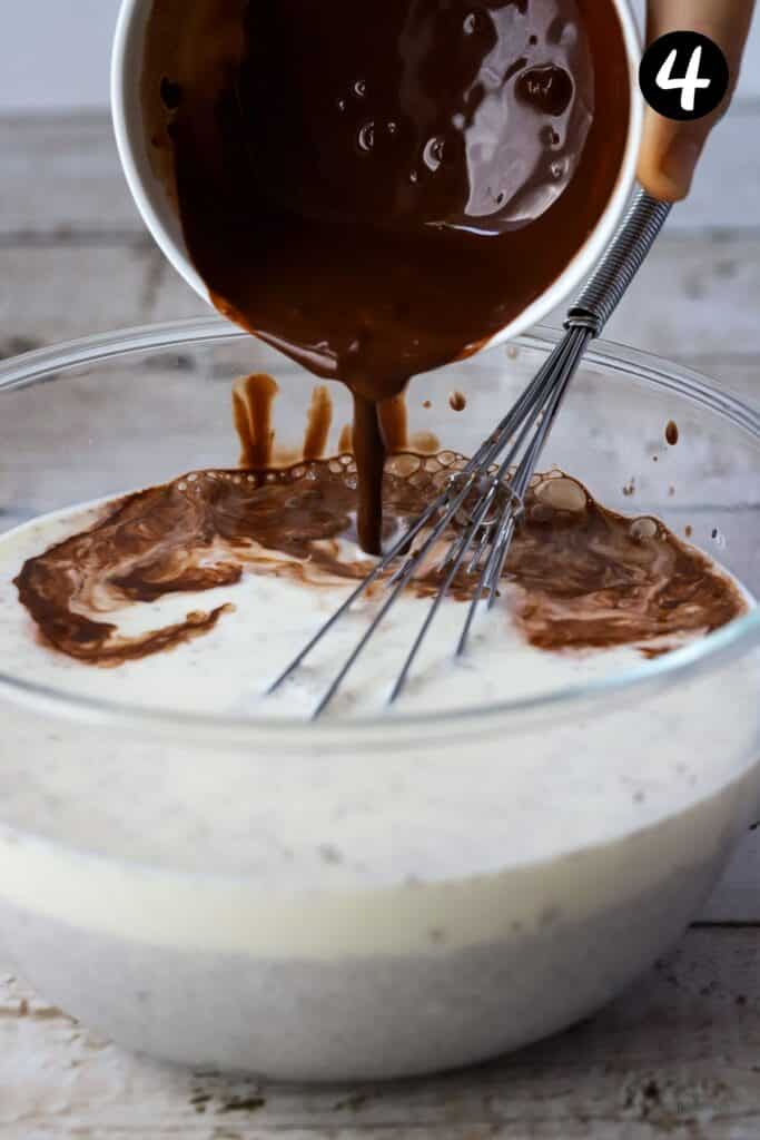 cocoa being added to chia pudding in a mixing bowl