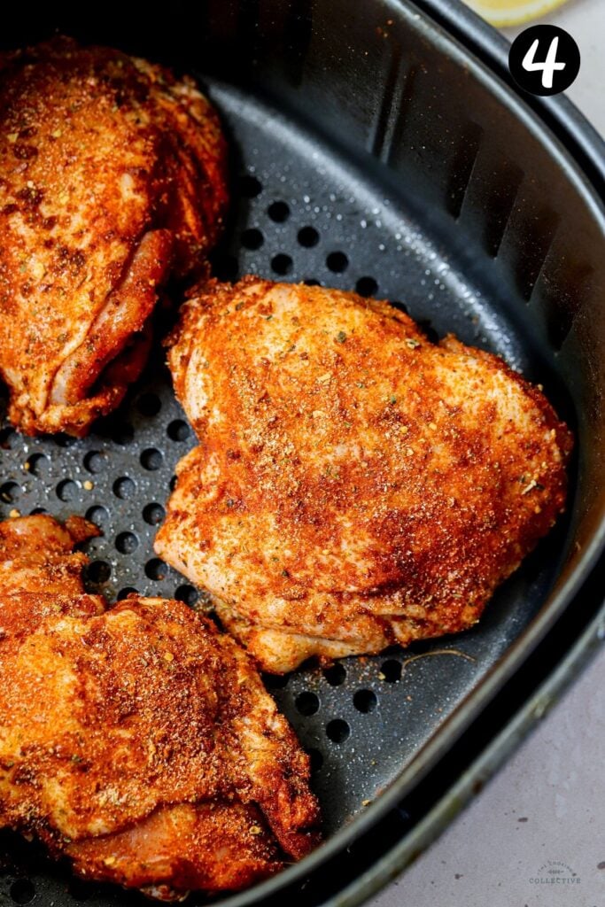 chicken thighs in an air fryer basket