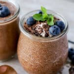 chia seed chocolate pudding in a glass jar with blueberries