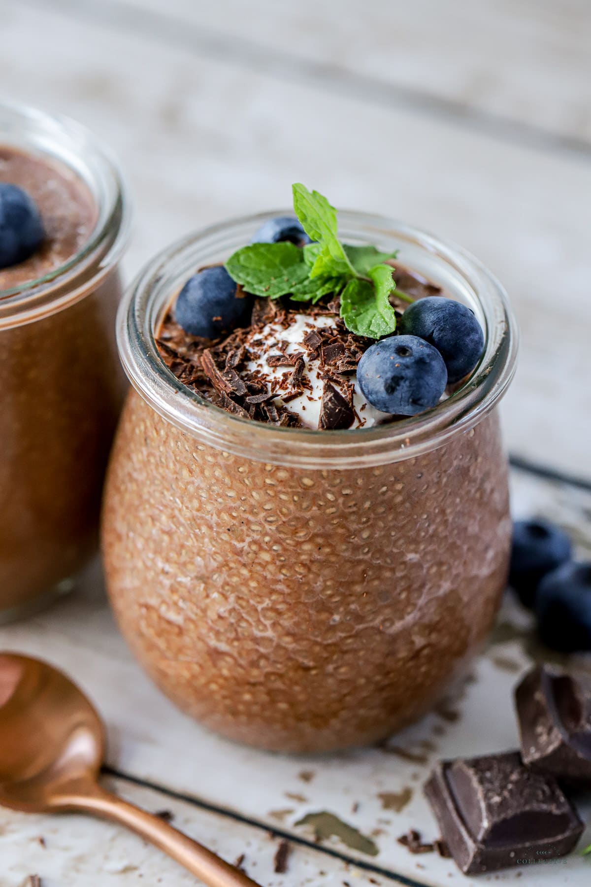 chia seed chocolate pudding in a glass jar, topped with blueberries