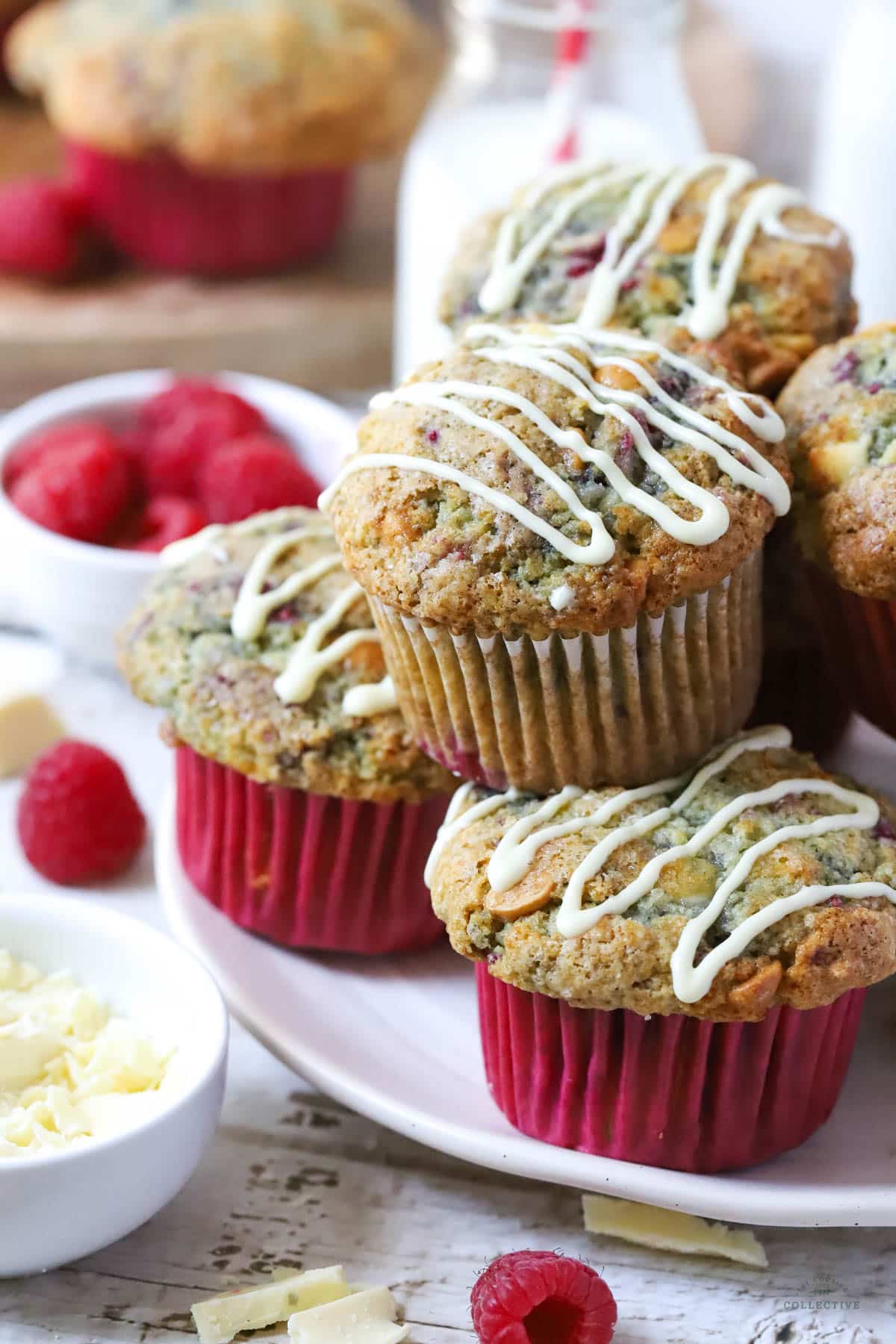 raspberry muffins on a white plate with white chocolate on top
