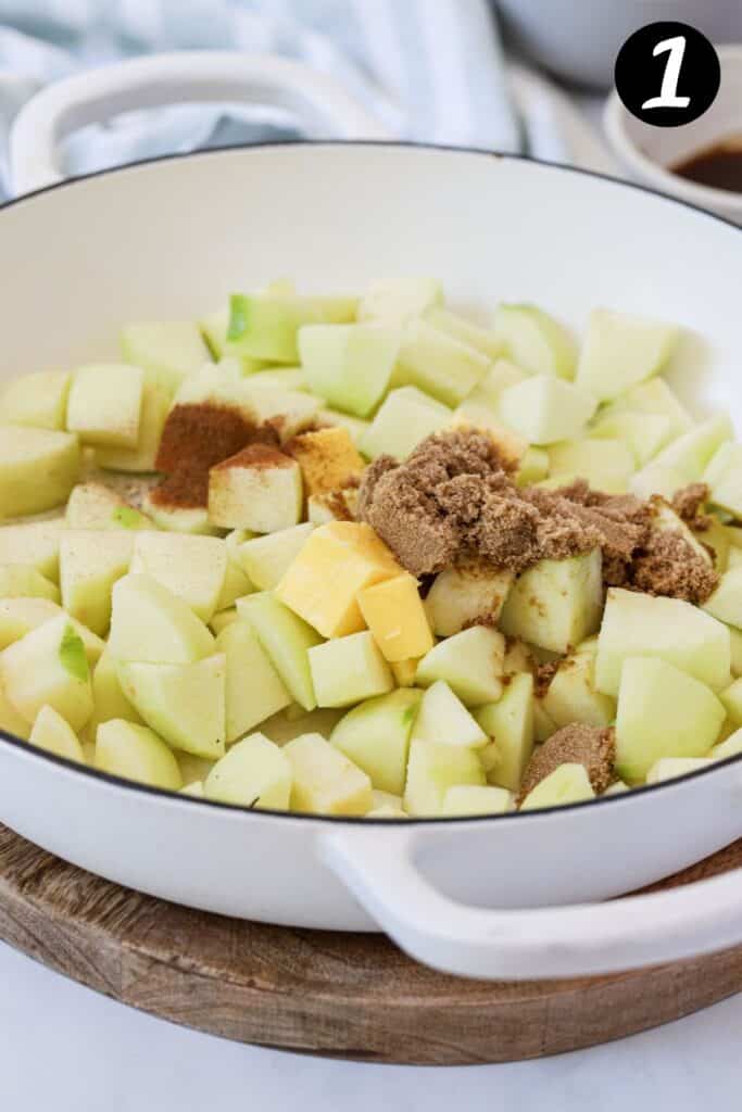 cubed apples, brown sugar and butter in a white pan