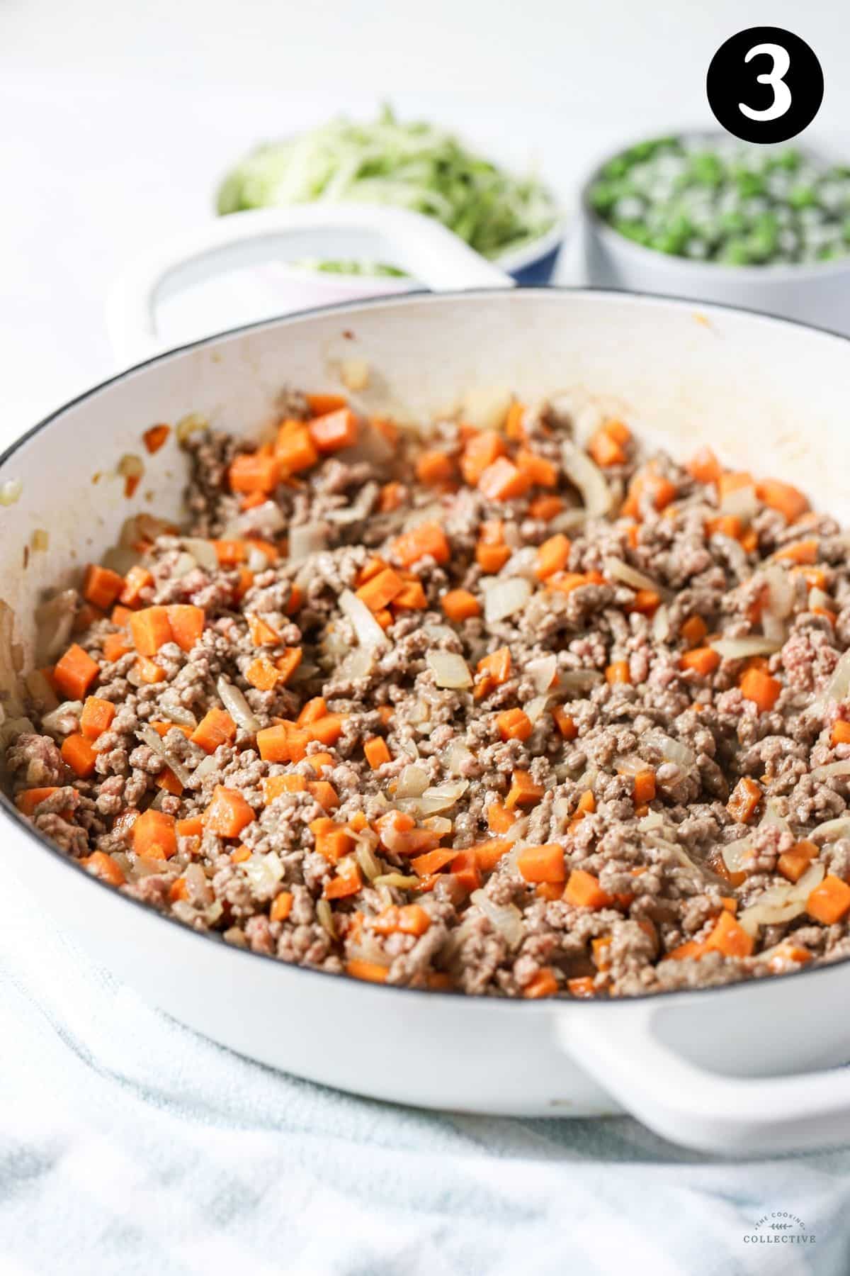 browned beef mince in a pan with diced carrot