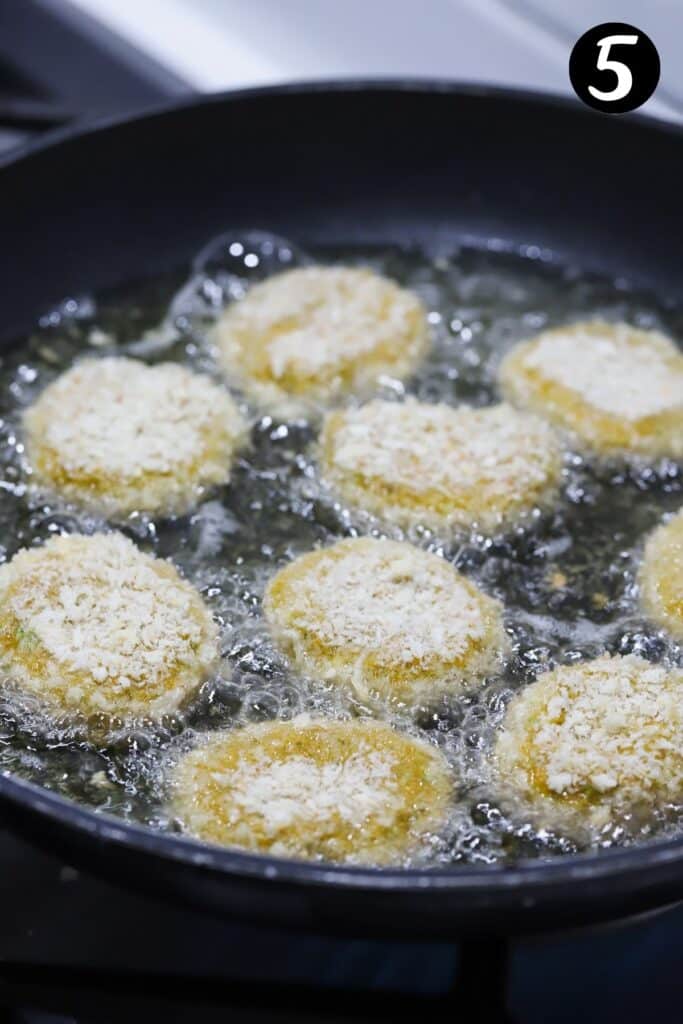 nuggets frying in a pan with oil