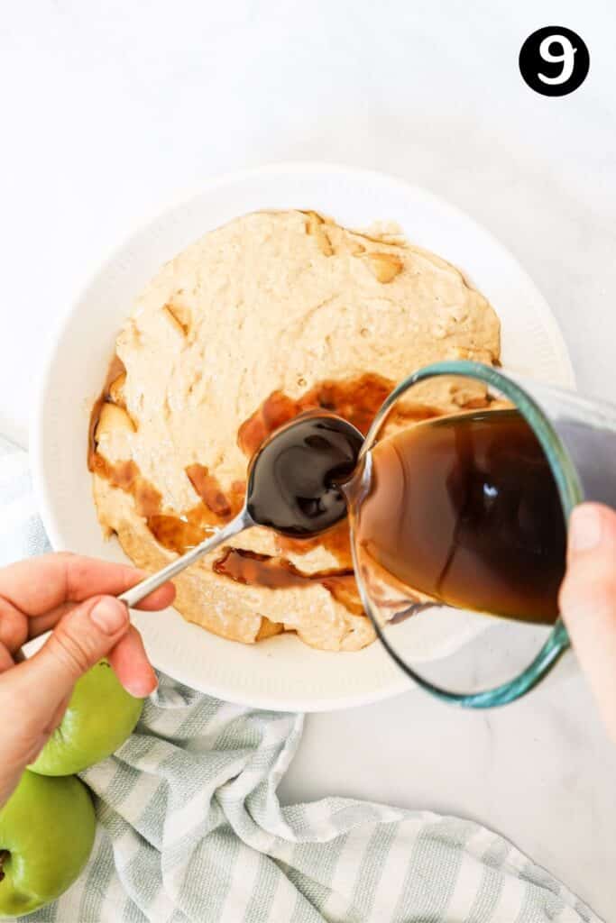 caramel sauce being poured over sponge cake batter in a dish