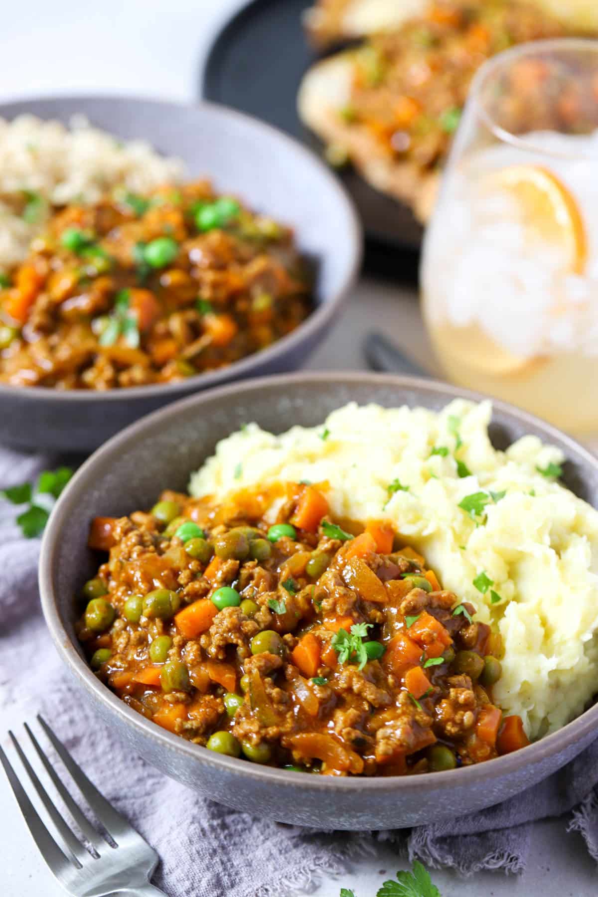 bowls of mince and vegetables with mashed potatoes