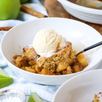 sponge pudding with cooked apples and a scoop of ice cream