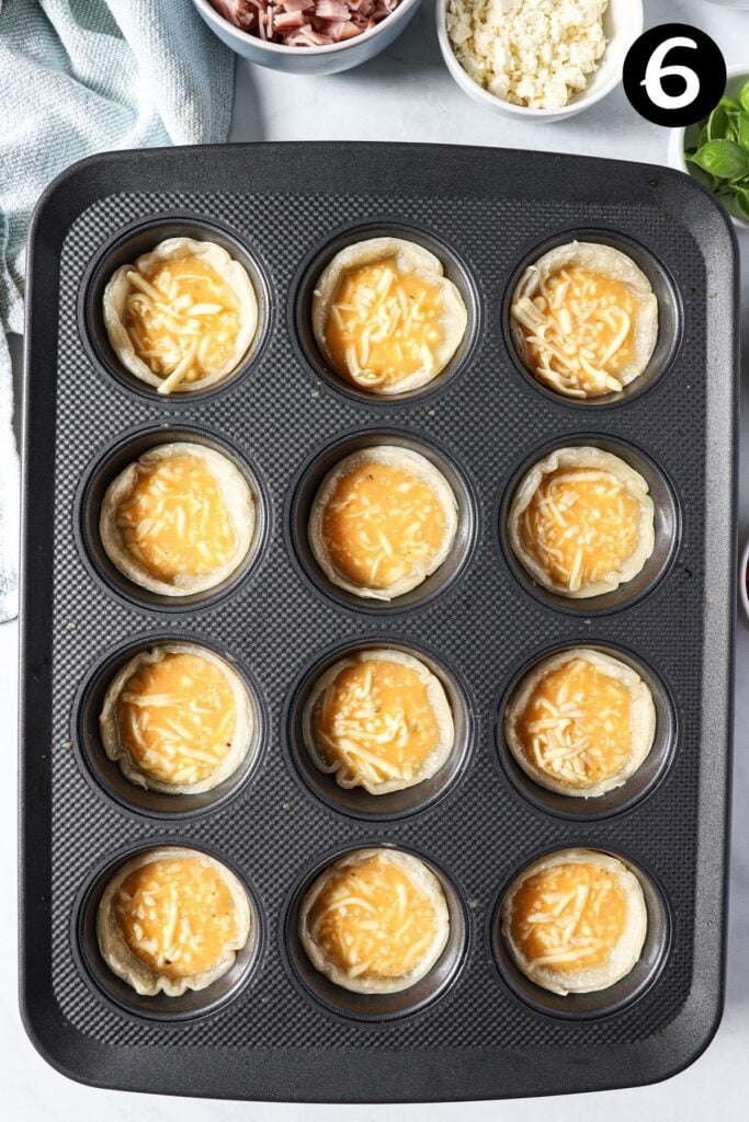 egg mixture in puff pastry cases in a muffin tray