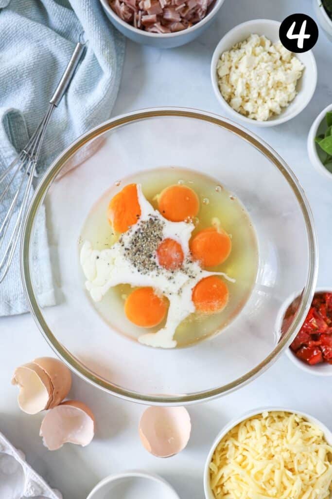 eggs in a bowl with milk and pepper