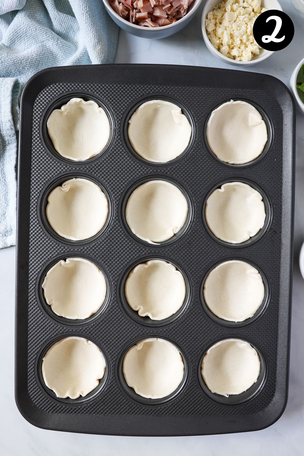 puff pastry circles pressed into a muffin tin