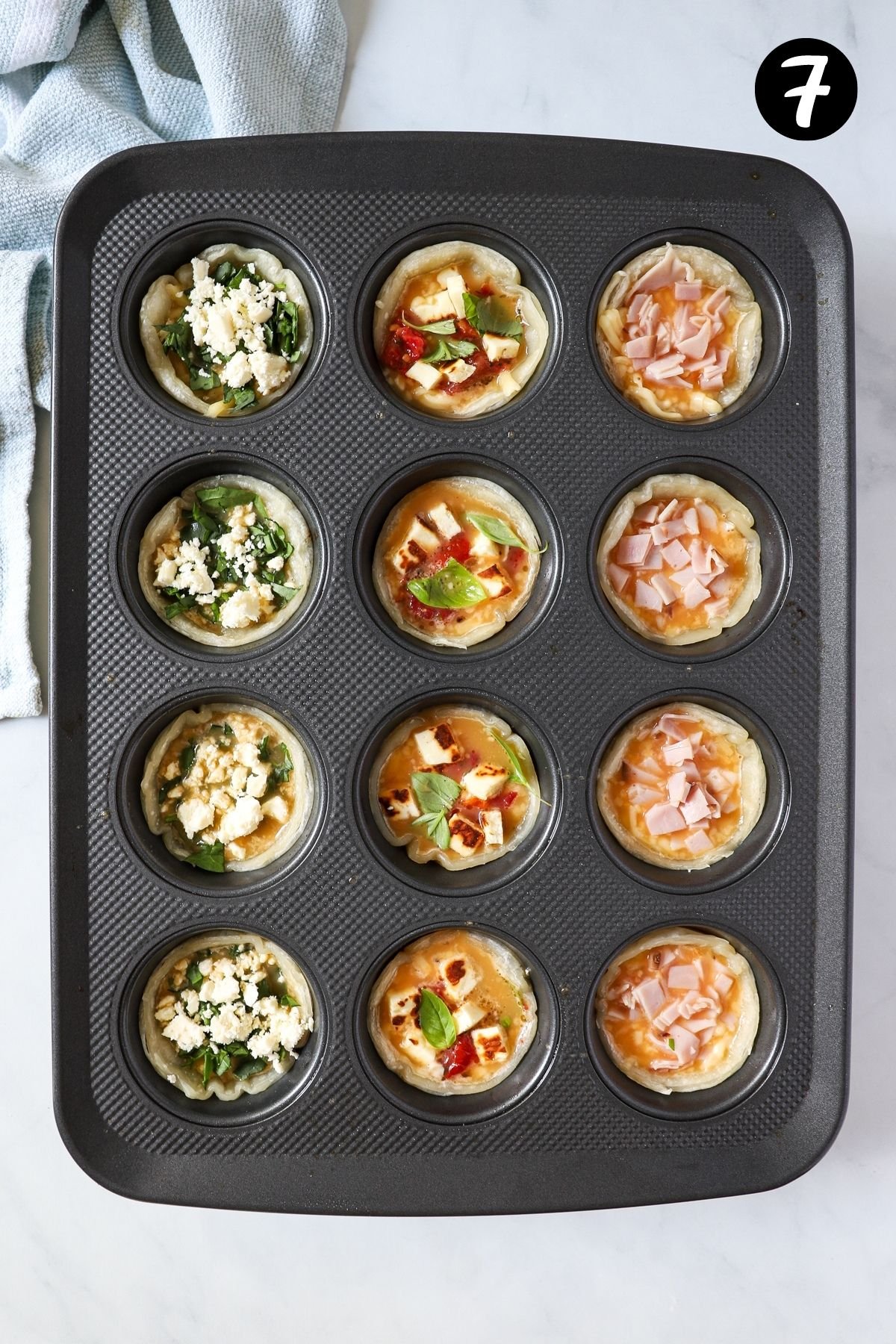 uncooked quiches in a muffin tray