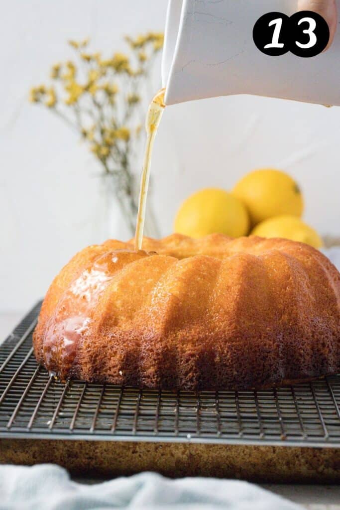 a jug pouring lemon syrup over a cake