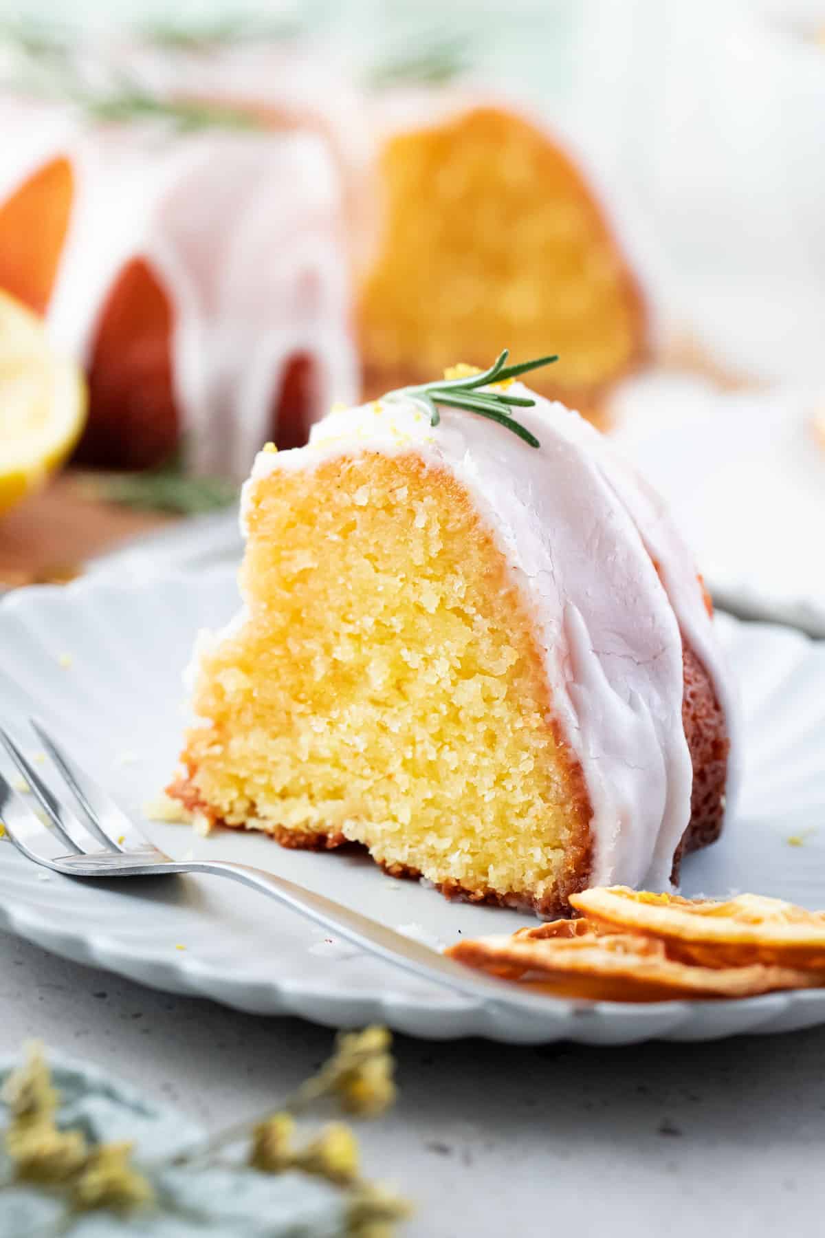 a piece of lemon syrup cake on a white plate