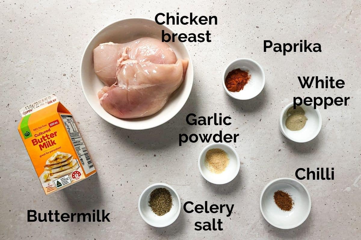 all ingredients for buttermilk fried chicken laid out on a table
