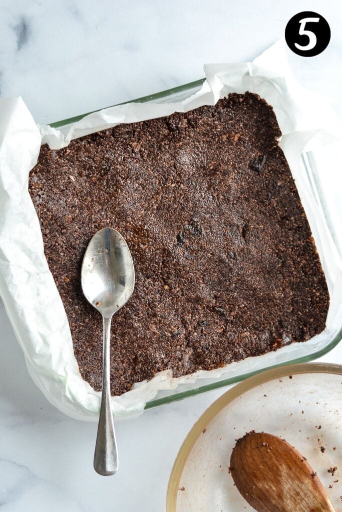 weetbix slice mixture pressed into a lined baking tray