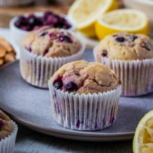 lemon blueberry muffins on a grey plate.