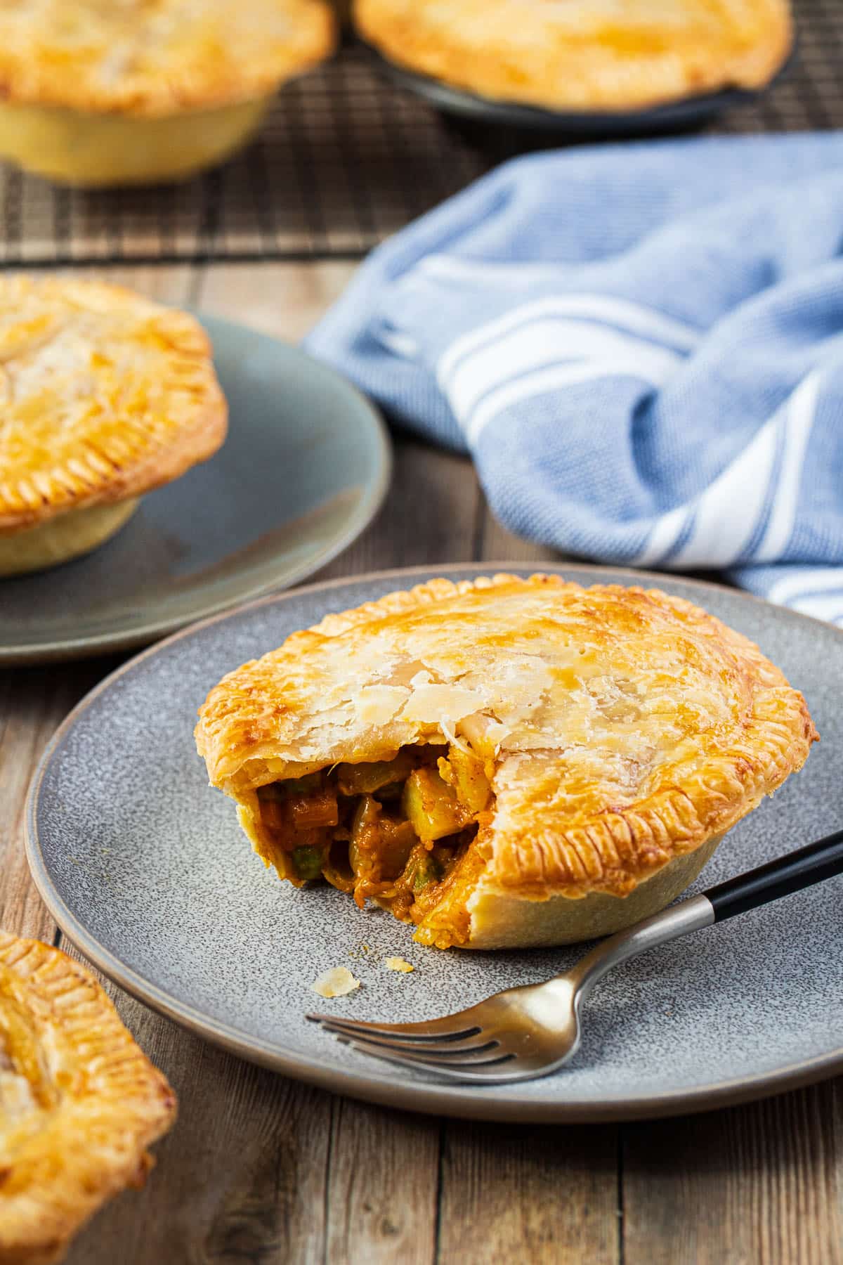 vegetable curry pies on a table with plates