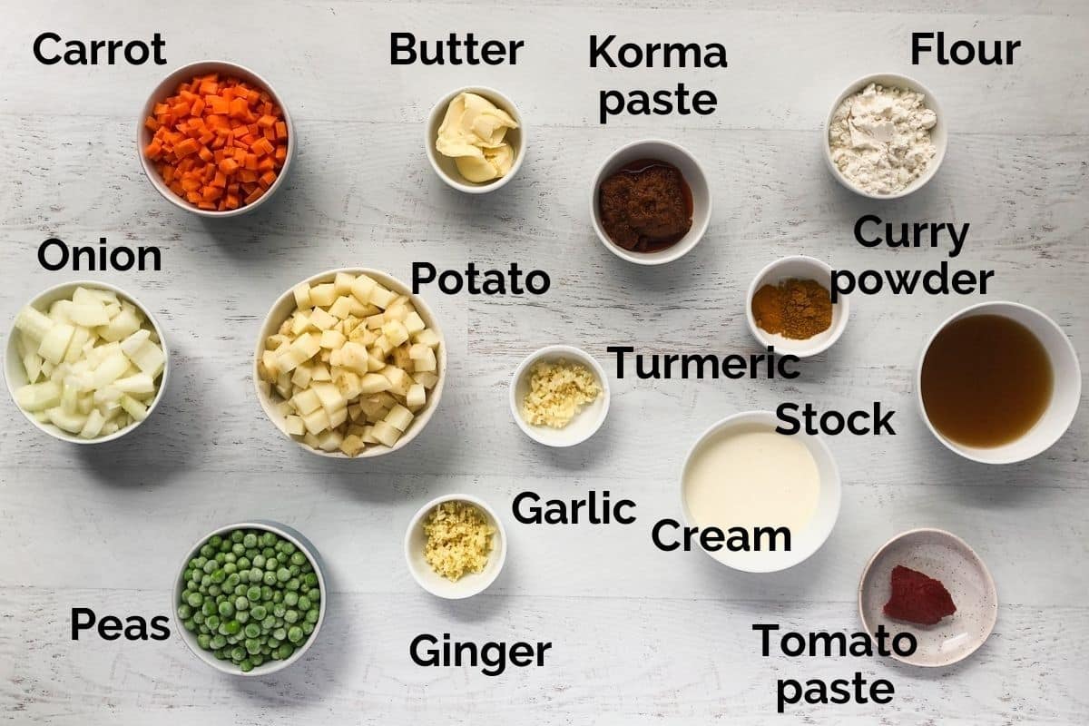 ingredients for vegetable curry pies laid out on a table.
