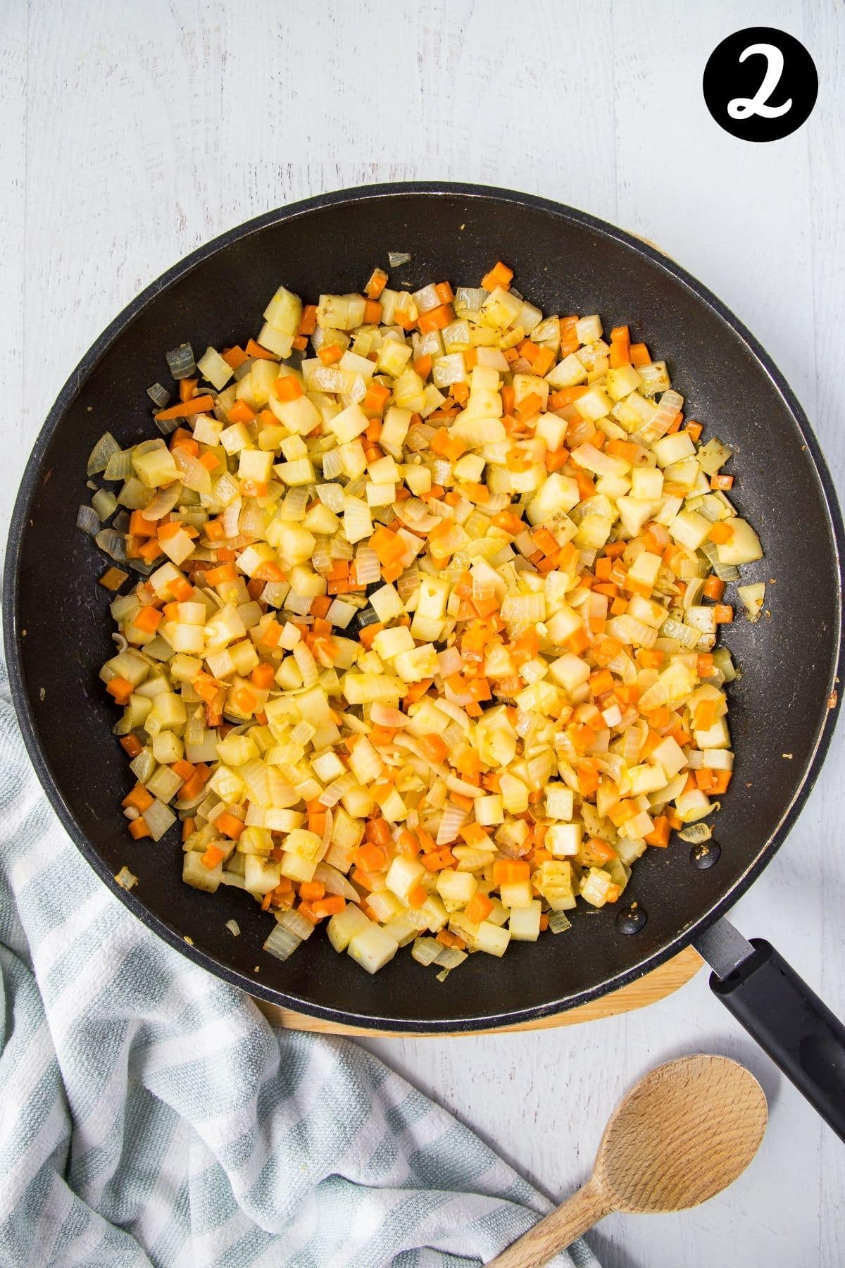 diced vegetables cooking in a frying pan